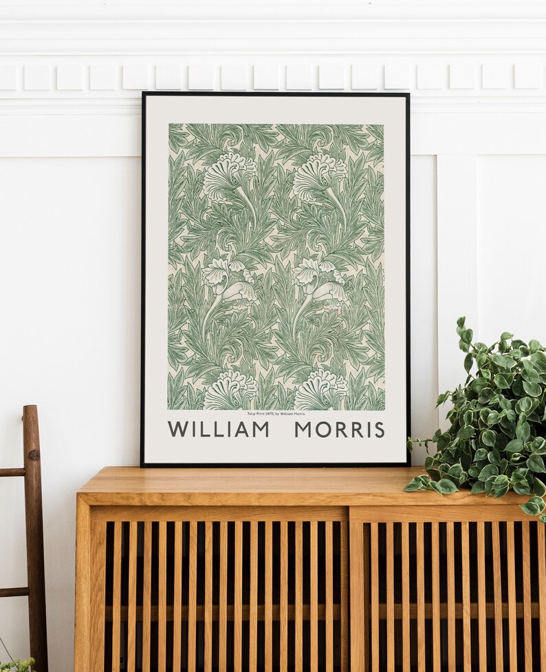 May include: A framed print of a green and white floral pattern with the text "William Morris" at the bottom. The print is on a light beige background.