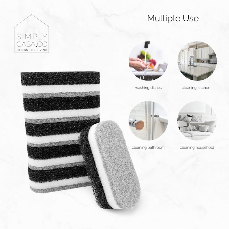 May include: A set of two black and gray cleaning sponges. The sponges are made of a textured material and are designed for multiple uses, including washing dishes, cleaning the kitchen, cleaning the bathroom, and cleaning the household. The image includes the text "SIMPLY CASA.CO DESIGN FOR LIVING" and "Multiple Use".