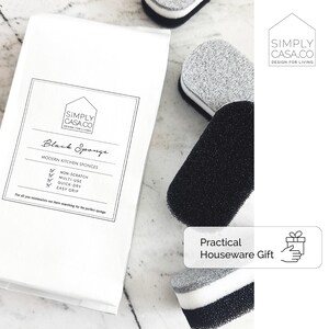 May include: A package of black kitchen sponges with the text "SIMPLY CASA.CO DESIGN FOR LIVING" and "Black Sponge" on the front. The package also includes the text "MODERN KITCHEN SPONGES" and a list of features: "NON-SCRATCH", "MULTI-USE", "QUICK-DRY", and "EASY GRIP".