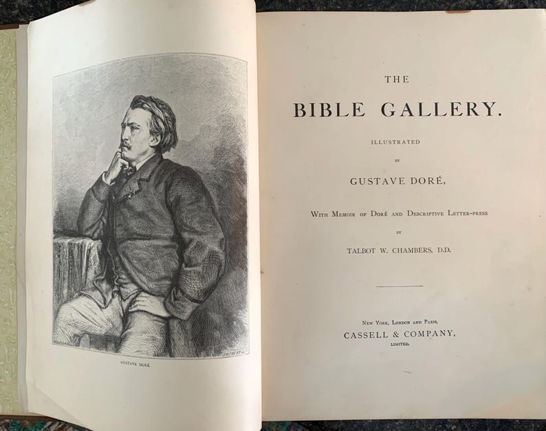 May include: A black and white illustration of Gustave Dor&eacute;, the illustrator of "The Bible Gallery". The book cover features the title "The Bible Gallery" and the illustrator's name, "Gustave Dor&eacute;".