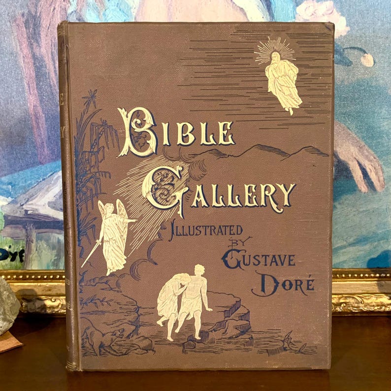 May include: A brown book with gold lettering on the cover. The title is "Bible Gallery" illustrated by Gustave Dor&eacute;.