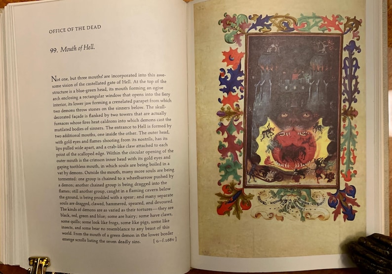 A page from a book with a description of the mouth of hell. The text reads 'Office of the Dead, 99. Mouth of Hell.' The text describes the mouth of hell as a blue-green head with a rectangular window that opens into a fiery interior. The text also describes the mouth of hell as having two towers that are actually furnaces whose fires heat caldrons into which demons cast the mutilated bodies of sinners.