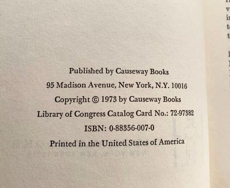 May include: Close-up of a book page with text. The text includes the publisher's name, address, copyright information, Library of Congress catalog card number, ISBN, and the phrase "Printed in the United States of America."