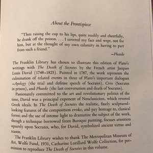 May include: A black and white illustration of a book with the title "The Death of Socrates" by Plato. The text describes the book's illustration by Jacques Louis David, a French artist, and the historical context of the painting.