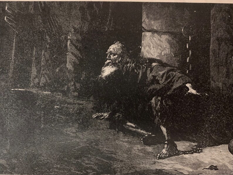May include: A detailed black and white illustration depicts an elderly man with a long beard, chained in a dark, stone-walled environment. The man is kneeling, with a chain around his ankle. A small rat is visible.