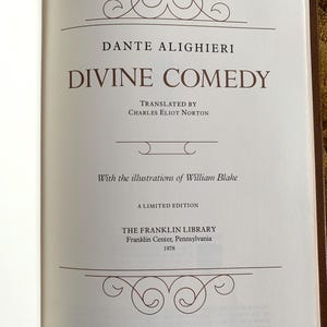May include: A white book cover with a brown title and text. The title is "DANTE ALIGHIERI" and the subtitle is "DIVINE COMEDY". The book is a limited edition from The Franklin Library, Franklin Center, Pennsylvania, 1978.