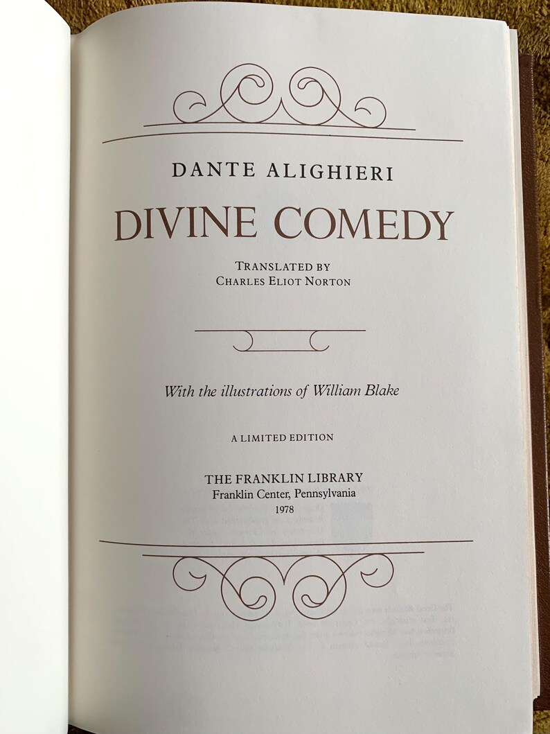 May include: A white book cover with a brown title and text. The title is "DANTE ALIGHIERI" and the subtitle is "DIVINE COMEDY". The book is a limited edition from The Franklin Library, Franklin Center, Pennsylvania, 1978.