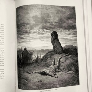 May include: A black and white illustration of a lion standing on a rock, looking at a man lying on the ground. The man is dead, and the lion has killed him. The text "THE PROPHET SLAIN BY A LION" is printed below the image.