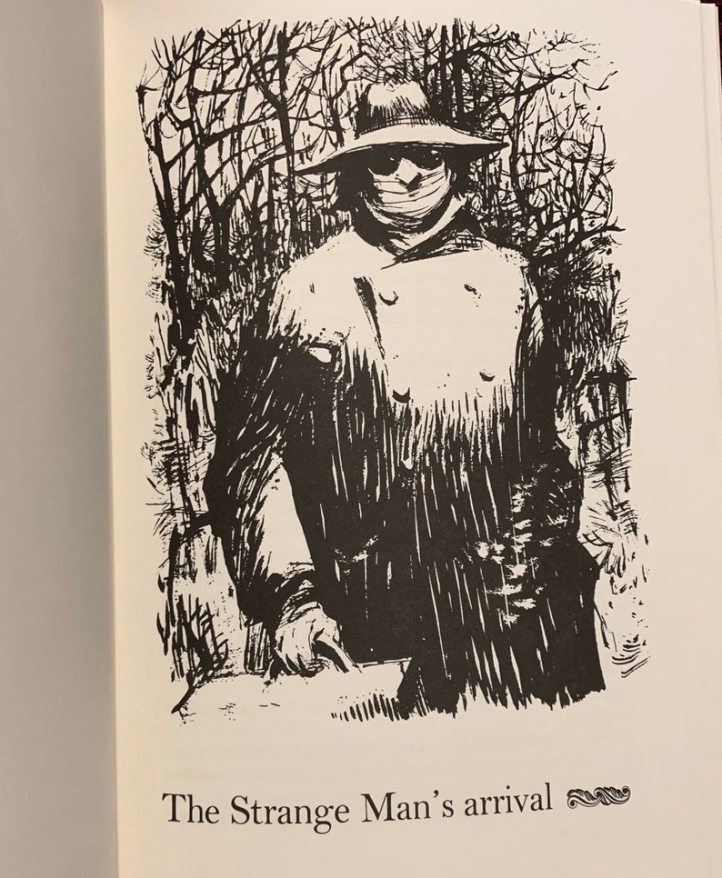 May include: Black and white illustration of a person wearing a hat and a mask, standing in a forest. The text "The Strange Man's arrival" is below the image.