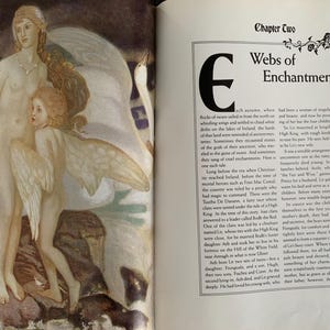 May include: An open book with an illustration of three women with wings, one of whom is riding a swan. The text on the page reads "Chapter Two Webs of Enchantment".