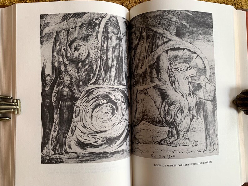 May include: A black and white illustration of a scene from Dante's Inferno. The image depicts a woman with wings addressing a man from a chariot, with a swirling vortex in the background.