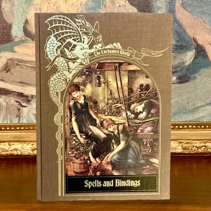 May include: A vintage book cover with a brown background and gold accents. The cover features a dragon illustration and the text "The Enchanted World" and "Spells and Bindings".