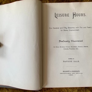 May include: Open book titled "LEISURE HOURS" with text and illustrations. The book is open to a page with text, including the title and author's name. A decorative metal hand holds the book open.