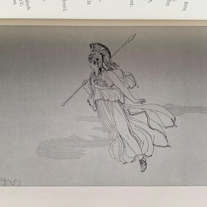 以下が含まれることがあります： 黒いハンドルと「But First, Coffee」のテキストが黒い太字で書かれた白いセラミックマグ。マグカップは木製の表面に置かれています。