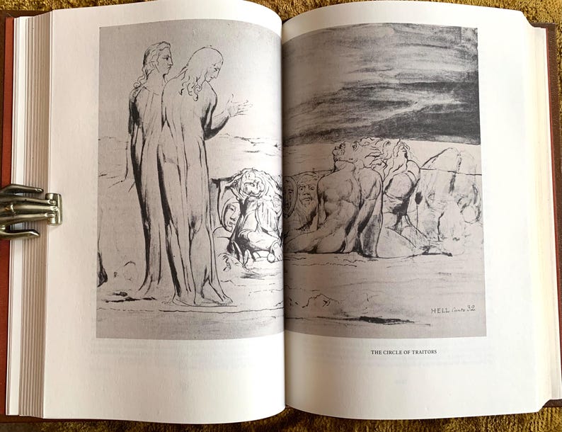 May include: A black and white illustration of a scene from Dante's Inferno. The image depicts two figures standing in the foreground, with a group of figures in the background. The text "The Circle of Traitors" is printed below the image.