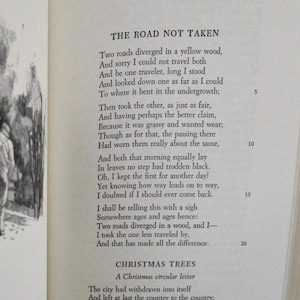 A page from a Robert Frost leather bound Easton Press book with the poem 'The Road Not Taken' by Robert Frost.