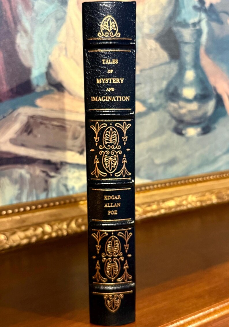 Vintage Leather-bound edition of “Tales of Mystery and Imagination” by Edgar Allan Poe with ornate gold detailing on the spine.
