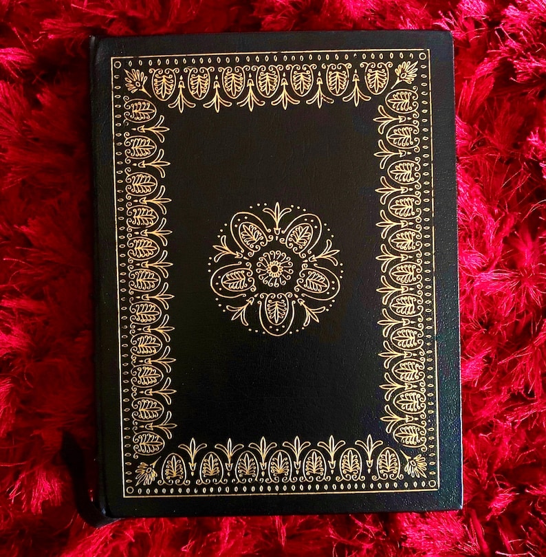 Ornate vintage leather bound book cover with gold floral design, Edgar Allan Poe collectible illustrated edition.