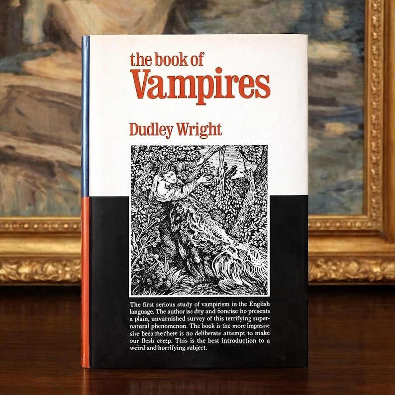 May include: The book cover features the title "the book of Vampires" in red letters above the author's name, Dudley Wright. The cover has a black and white illustration of a person in a forest. The book's spine is blue and orange.