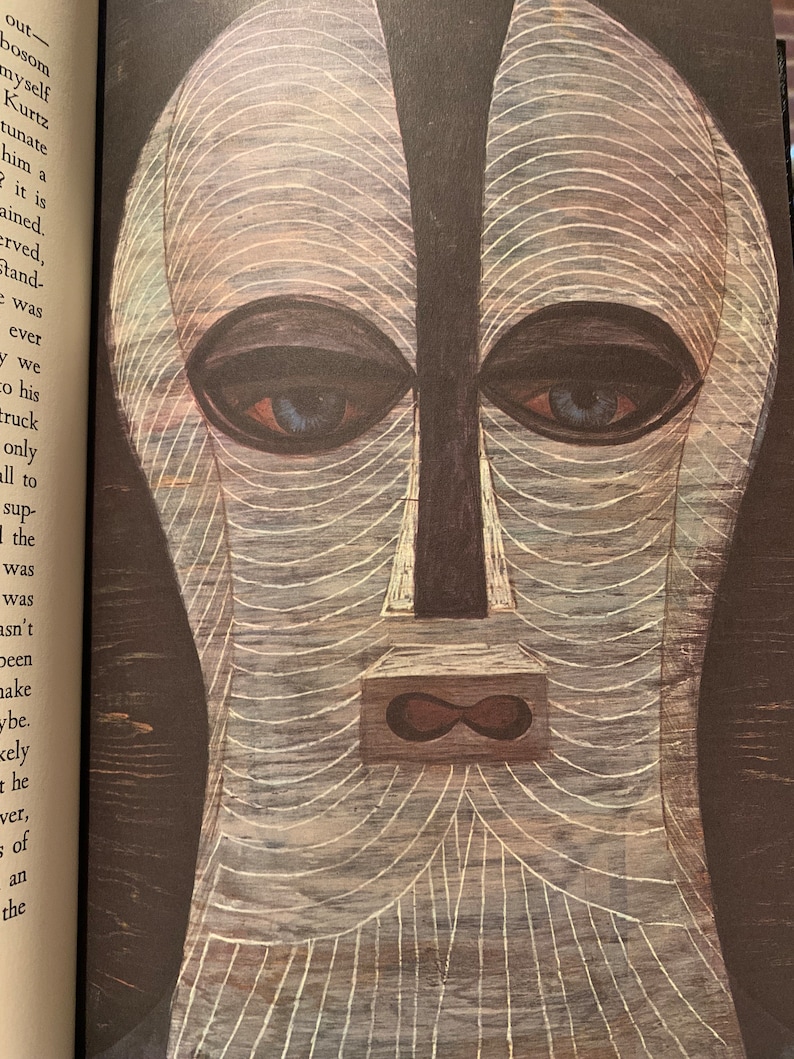 Black and white illustration from Heart of Darkness – Easton Press 1980 edition. Features a tribal mask or symbolic artwork tied to the novel’s themes of colonialism and darkness. A richly illustrated collector’s edition for literary enthusiasts.