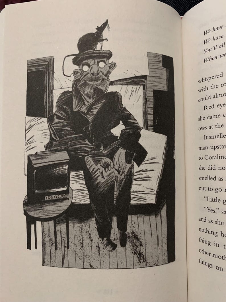 May include: A black and white illustration of a seated figure wearing a coat and a flat cap with a small rodent perched on top. The figure has glowing white eyes and a beard. A small television sits on a round table to the left of the figure.
