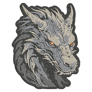 May include: Embroidered patch of a wolf's head with a detailed design. The wolf has a gray and white fur pattern with orange eyes.