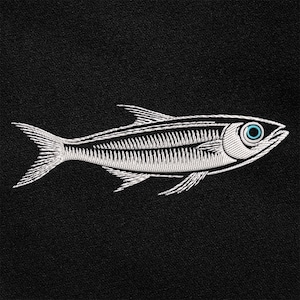 May include: Embroidered fish design in white on a black background. The fish has detailed lines and a blue eye. The design is likely for apparel or home decor.