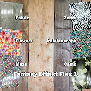 Puede incluir: Surtido de láminas de vinilo con patrones para proyectos de manualidades. Las láminas presentan diseños como tela, cebra, flores, caleidoscopio, laberinto, camuflaje, etc. El texto "Fantasy Effekt Flex 1" está impreso debajo de las láminas.