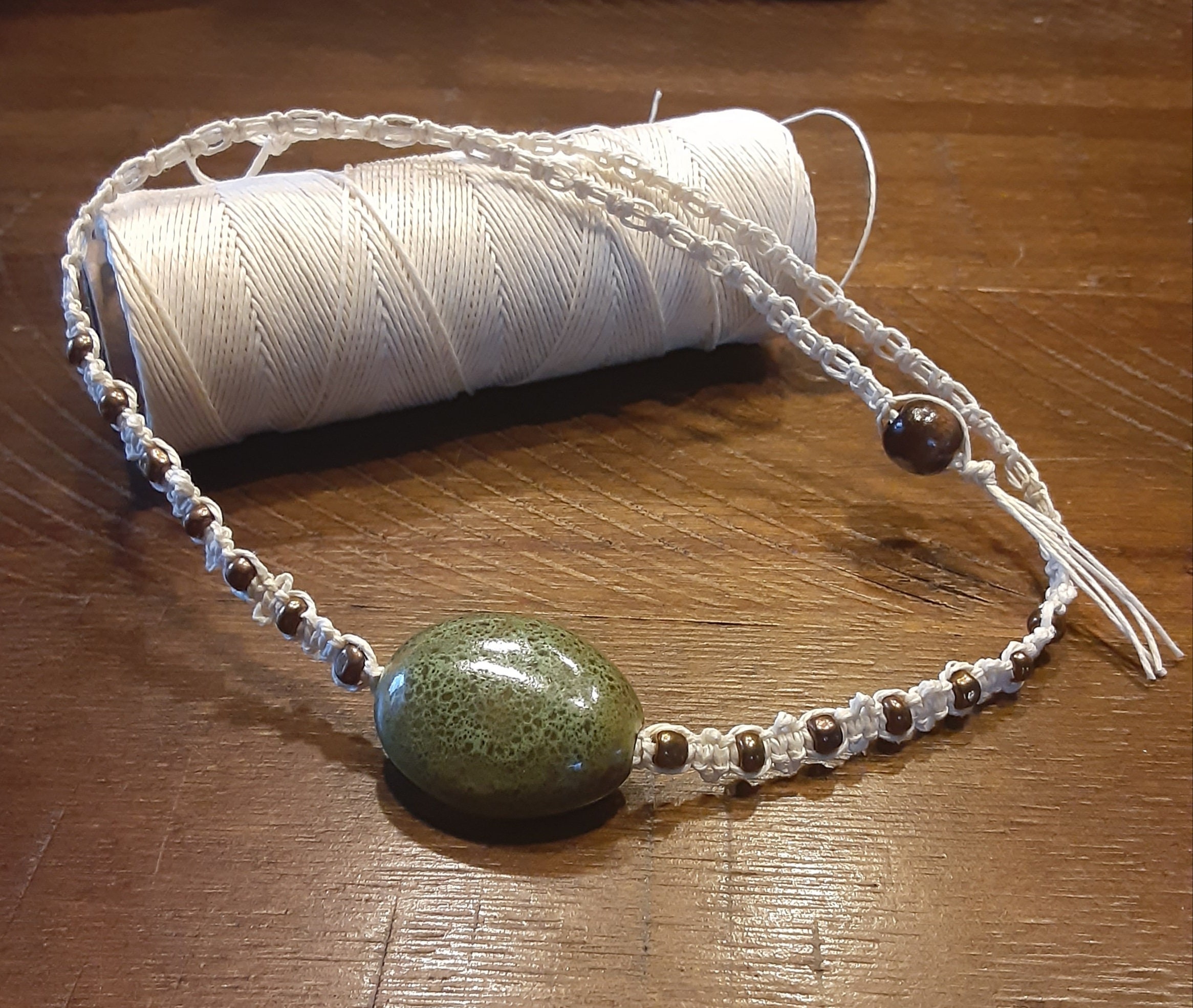 Hemp necklace. Glass Center bead with bronzed colored beads Etsy
