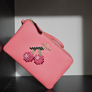 coach double wristlet with custom Swarovski cherry
