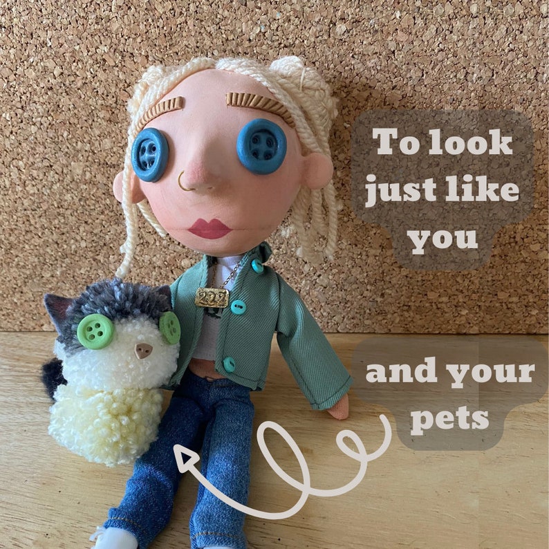 May include: A handmade doll with button eyes and a small cat plushie. The doll wears a green jacket, blue jeans, and a necklace. The cat plushie has green button eyes and a black and white fur pattern. Text on the image reads "To look just like you and your pets."