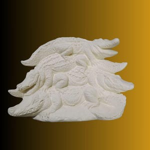 May include: A white sculpture of several alligators stacked on top of each other. The alligators are detailed with textured skin and open mouths. The sculpture is set against a gradient background of black and gold.