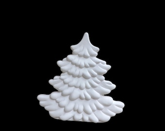 May include: A white, three-dimensional Christmas tree ornament. The tree has a detailed, layered design with rounded edges, and is set against a solid black background. The ornament is a festive decoration.
