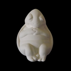 May include: White ceramic figurine of a turtle with its eyes closed, curled up in a sleeping position.