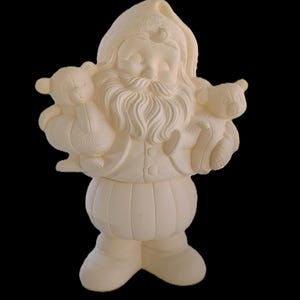 May include: An unpainted ceramic figurine of Santa Claus wearing a hat and a long coat, holding a teddy bear in each arm. The figure features a detailed beard, a rounded belly, and boots, presented in a solid off-white matte finish.