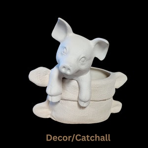 May include: White ceramic piggy bank planter with a textured surface. The piggy bank is sitting on a stack of two ceramic rings. Decor/Catchall.