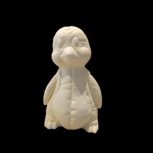 May include: A ceramic penguin figurine in a creamy white color. The penguin has a rounded body, small wings, and a prominent beak. The figurine is unpainted and has visible seam lines, suggesting it is ready for customization.
