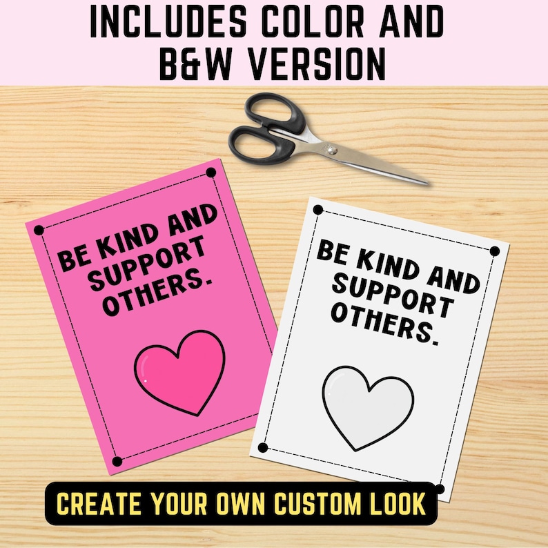 May include: Two rectangular cards with black dashed borders and the text BE KIND AND SUPPORT OTHERS. One card has a pink background with a pink heart, and the other is white with a black heart outline. A pair of black scissors is positioned above.