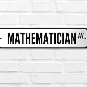 May include: A white street sign with black text that reads "MATHEMATICIAN AV."