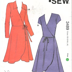 May include: Kwik Sew pattern 3489 for misses' sizes XS-XL. The image shows two wrap dress designs, one in coral and the other in purple. The pattern includes a tie closure and long or short sleeves. The text "Kwik Sew" is displayed.