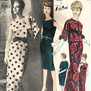 May include: Vintage Vogue Paris Original sewing pattern featuring three dress designs. The cover art showcases illustrations of the dresses, including a polka-dot dress, a dark green dress, and a floral print ensemble. The pattern is designed by Patou.