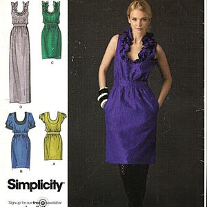May include: A Simplicity sewing pattern featuring designs by Cynthia Rowley. The image shows a woman wearing a purple dress with a ruffled neckline. The pattern includes options for various dress styles, with sizes D5 4,6,8,10,12.