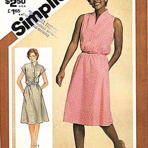 May include: Simplicity sewing pattern 9905, size 14 Miss. The pattern features a pink dress with white polka dots, a matching belt, and a V-neck. The image also shows a drawing of a similar dress in a different color.