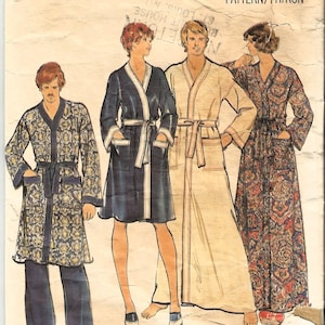 May include: A vintage sewing pattern for three robes. The pattern is from Butterick and is for a medium size. The pattern number is 4158 and the price is $1.25. The robes are in different colors and patterns. One is blue with white trim, one is beige, and one is red and blue with a floral pattern.