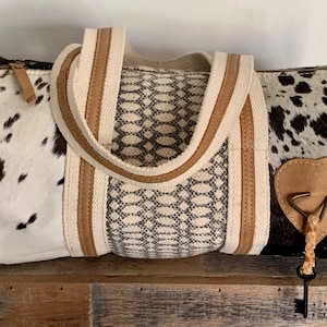 Cowhide & upcycled canvas roll style medium duffle shoulder handbag