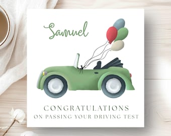 May include: A square greeting card with a green convertible car illustration and colorful balloons. The card reads "Samuel" in cursive and "Congratulations on passing your driving test" in a serif font. The card is on a white background.