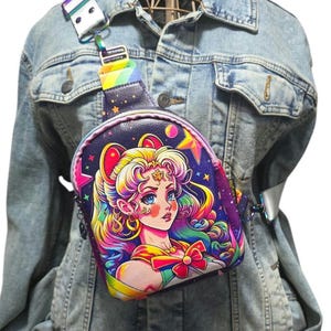 May include: A small, colorful, anime-inspired crossbody bag with a rainbow strap. The bag features a cartoon image of a woman with blonde hair and a pink bow. The background is a dark blue with stars and planets.