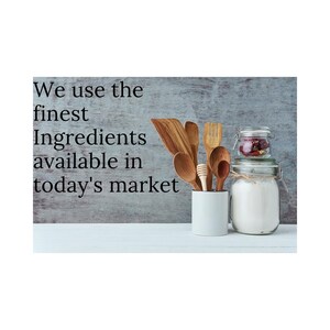 May include: We use the finest ingredients available in today's market. A white ceramic jar with a lid, a glass jar with a lid, and a wooden utensil holder with wooden spoons, a wooden fork, and a wooden honey dipper.