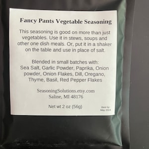 May include: A black and white label with the text "Fancy Pants Vegetable Seasoning" and a list of ingredients including sea salt, garlic powder, paprika, onion powder, onion flakes, dill, oregano, thyme, basil, and red pepper flakes. The label also includes the text "SeasoningSolutions.etsy.com", "Saline, MI 48176", "Net wt 2 oz (56g)", and "Best by: May 2024".