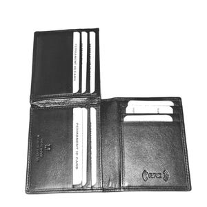 May include: A black leather bifold wallet featuring multiple card slots, including two labeled Permanent ID Card, and a dedicated RFID protection symbol embossed on the interior. The wallet is open, displaying several white cards inserted.